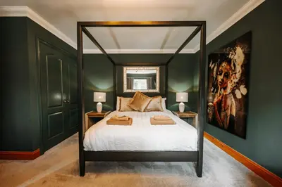 a bedroom with a canopy bed with two lamps at Boutique Shrewsbury Rooms in Shrewsbury