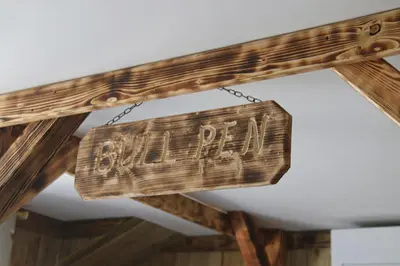 a wooden sign that reads old party hanging from a ceiling at The Moo-tel at Moody Meadows in Aberaeron