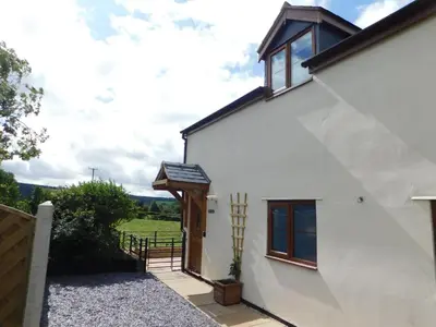 a white house with a pathway leading up to the door at Mossy Lodge in Shrewsbury