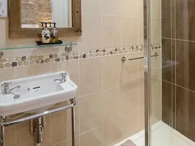 a bathroom with a sink and a shower at Walkmill Lodge in Wentnor