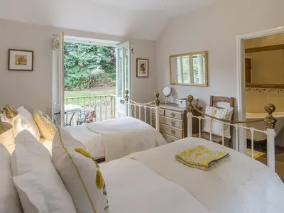 a bedroom with two beds and a balcony at Walkmill Lodge in Wentnor