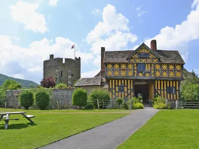 an old building with a castle and a picnic table at Mashers Barn in Bucknell