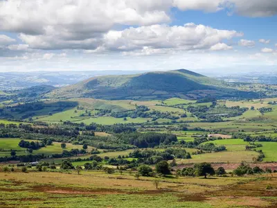 a view of a green valley with a mountain at Garden Lodge in Llanvair Waterdine