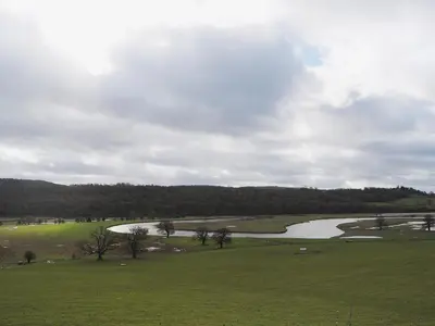 a view of a golf course with a river at Grove Sprightly Barn in Craven Arms