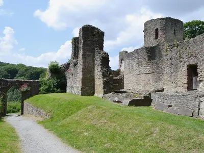 an old castle on a hill with a dirt road at Titchbourne Cottage in Clee Saint Margaret