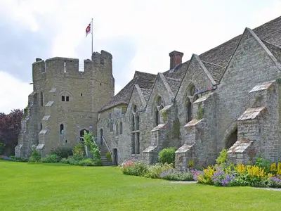 an old castle with a flag on top of it at Titchbourne Cottage in Clee Saint Margaret