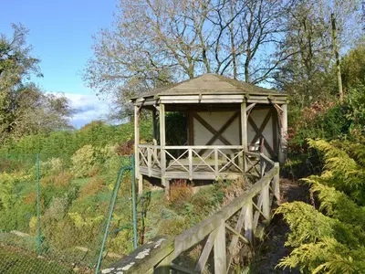a gazebo in the middle of a garden at Angel Barn in Farden