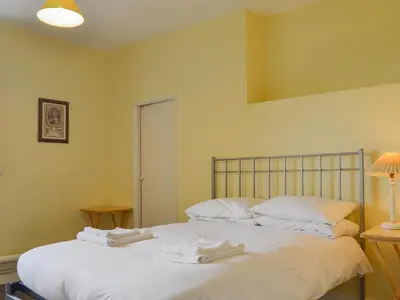 a bedroom with a bed with towels on it at Cronkhill Farmhouse in Wroxeter
