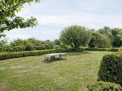 a picnic table in the middle of a field at Cronkhill Farmhouse in Wroxeter