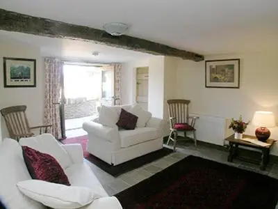 a living room with two white couches and chairs at Mouse Castle Barn in Hay-on-Wye