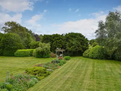 a lawn with a gazebo in a garden at The Stables in Eardisland