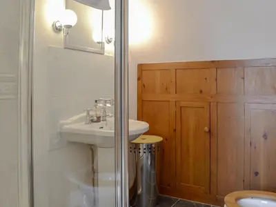 a bathroom with a sink and a toilet and a shower at The Stables in Eardisland
