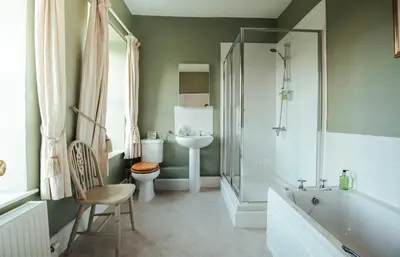 a bathroom with a tub and a sink and a toilet at Stone House Wales in Kington