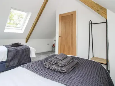 a bedroom with a bed with towels on it at The Larches in Bishops Castle