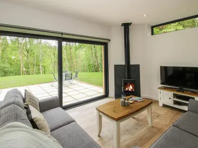a living room with a couch and a fireplace at The Larches in Bishops Castle