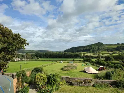 a view of a field with tents and trees at Ideal rural location for beaches, hills and town in Bow Street