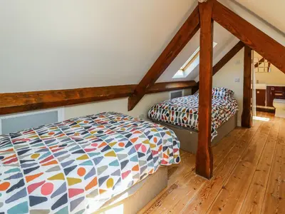 a bedroom with two beds in a attic at Awelfan in Newtown