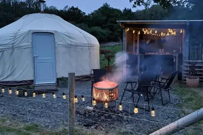 a yurt with a grill and chairs in front of it at Bronfelen Yurt in Cynghordy