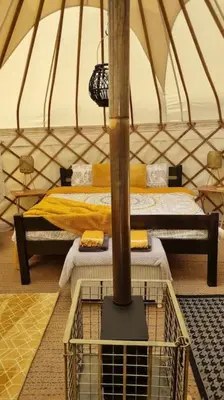 a bedroom with two beds in a yurt at Bronfelen Yurt in Cynghordy