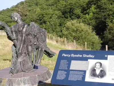 a statue of a boy with an angel at Glan Wye in Rhayader
