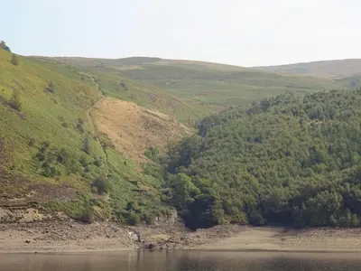 a view of a hillside with a body of water at Glan Wye in Rhayader