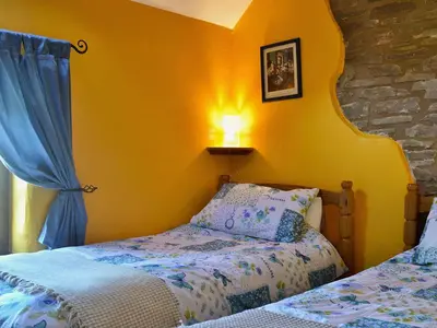 a bedroom with a bed and a lamp on a wall at The Bailey in Glasbury