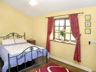 a bedroom with a bed and a window at The Bailey in Glasbury