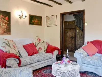 a living room with two couches and a table at Forget Me Not Cottage in New Radnor