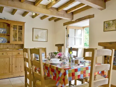 a dining room with a table and chairs at Ty Rhyd in Llanrhaeadr-ym-Mochnant