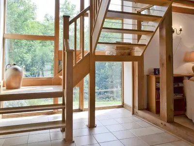a spiral staircase in a room with a large window at Ty Rhyd in Llanrhaeadr-ym-Mochnant
