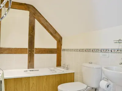 a bathroom with a toilet and a sink at Ty Rhyd in Llanrhaeadr-ym-Mochnant