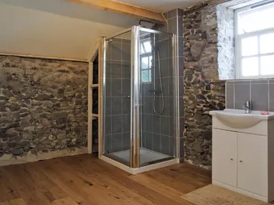 a bathroom with a shower and a sink at Hirros Hall Longhouse in Llanerfyl