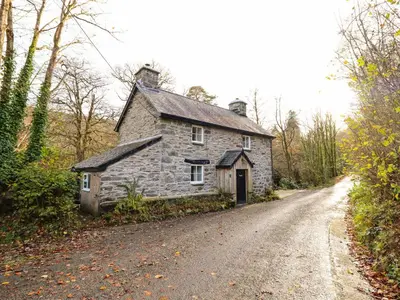 an old stone house on the side of a road at Pen y Bont in Machynlleth