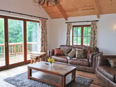 a living room with a couch and a table at The Farmhouse in Mydroilin