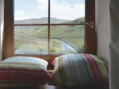 a window with a view of a mountain view at Llechwedd Mawr in Scyborycoed