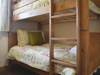 a bunk bed in a bedroom with a bunk bedutenewayangering at Llechwedd Mawr in Scyborycoed