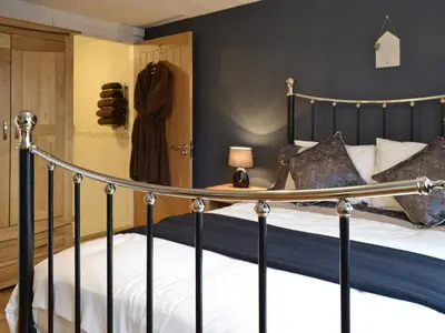 a bedroom with a bed and a closet at Cartws-Oh3 in Dihewid