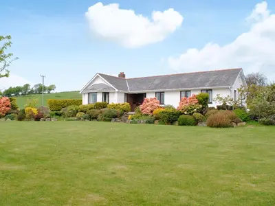 a house with a large yard in front of it at Bryneirin in Tal-gareg
