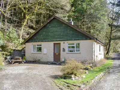 a small white cottage with a green roof at The Glen in Devils Bridge