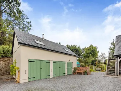 a garage with a green and white building at Field View in Cynghordy