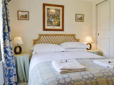 a bedroom with a bed with towels on it at Crogen Coach House - Oqr in Llandrillo
