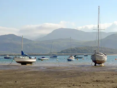 a group of boats sitting on the beach at Barreg in Barmouth