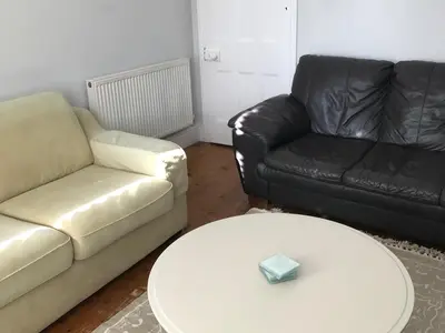 a living room with a couch and a table at Barreg in Barmouth