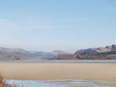 a large body of water with mountains in the background at Barreg in Barmouth