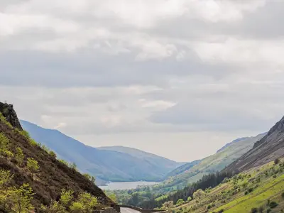 a view of a valley with a river and mountains at Hendre Barn Mawr in Abergynolwyn