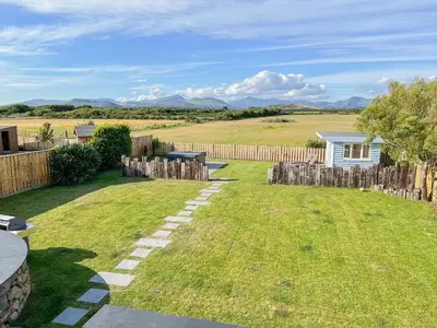 a backyard with a fence and a grass yard at Bod Eithin in Harlech
