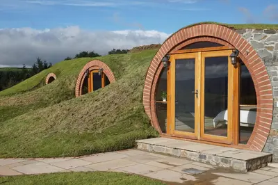 a building with a grassy hill with a door at Foxes View in Rhayader