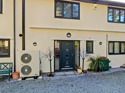 a house with a blue door and a fan at Bryn Mynach Guest House in Barmouth