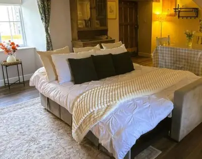 a bedroom with a large bed in a room at The Cottage at Sychnant Farm in Talgarth