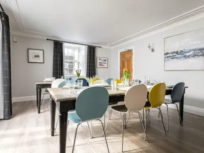 a dining room with a table and chairs at Fron Dderw in Bala